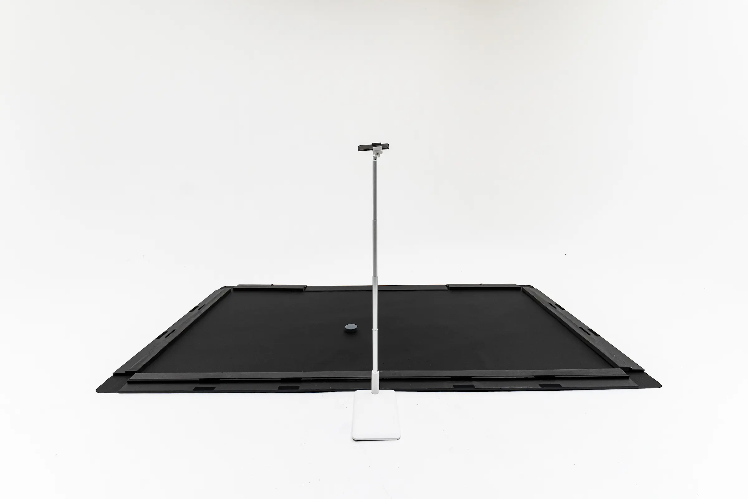 Danglemat with bumpers, puck, and device stand